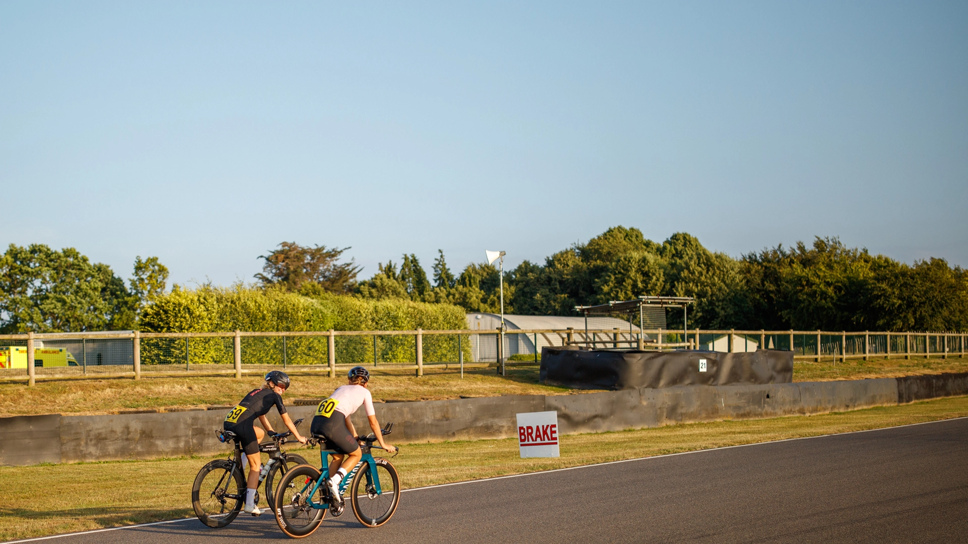 two people take part in a cycle time trial on a road
