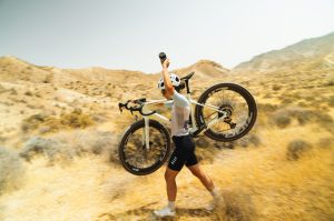 Megamo West woman carrying bike Megamo promotes all-new 2026 West gravel bike to UK audiences