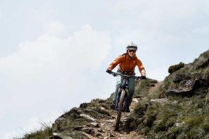Porsche E Bike Performance woman on MTB on trail decent Porsche E-Bike Performance to launch in-house battery production