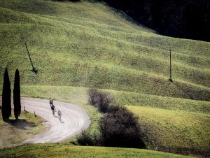 Strade riders on dustry white roads wide shot Rouleur Travel introduces its 2026 Ride Out events