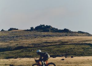 UC AW25 Dartmoor tor in background rider in foreground Universal Colours releases first drop of new AW25 collection