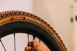 Vittoria T50 close up on rim with hand on valve Vittoria releases Terreno Pro Gravel Range