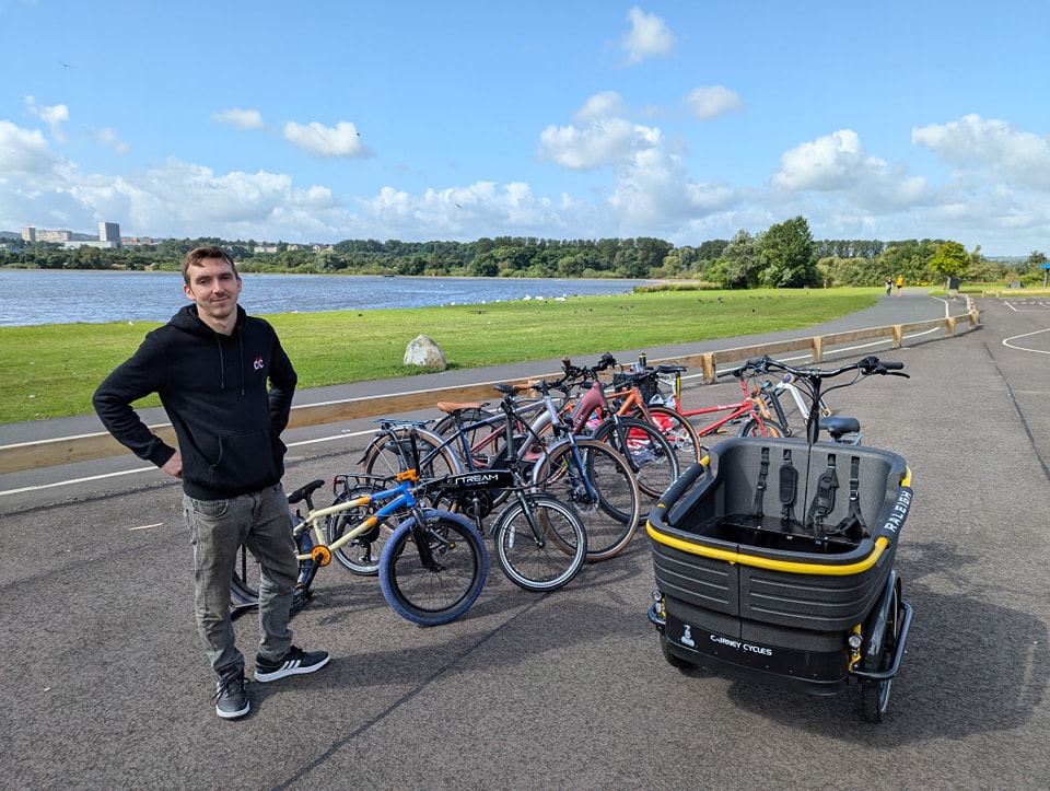 Connor Mooney of Cairney Cycles poses with a fleet of bikes and cargo bike