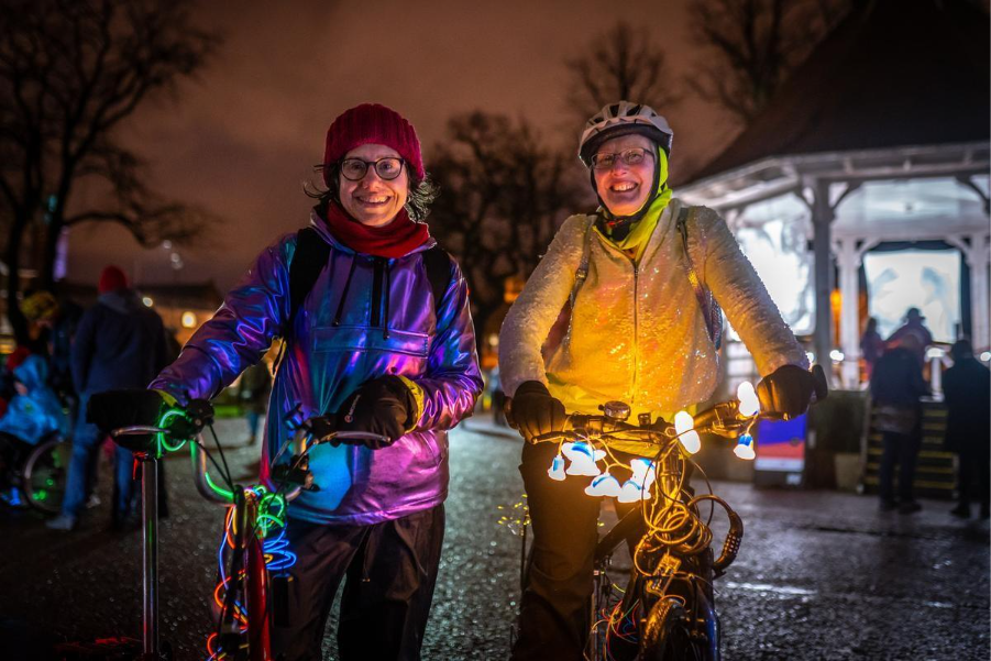 cycling uk ‘My ride. Our right’ campaign image two women pose with bikes at night